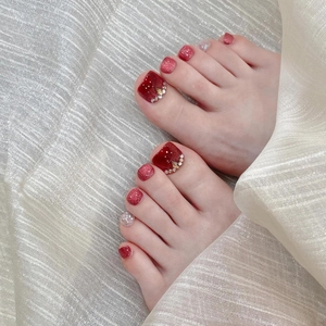 Handmade deep red press-on toenails with sparkling glitter and elegant rhinestone decor