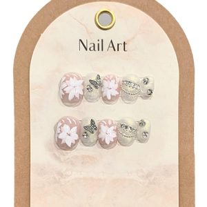 Handmade press-on nails featuring 3D floral designs and silver butterfly accents