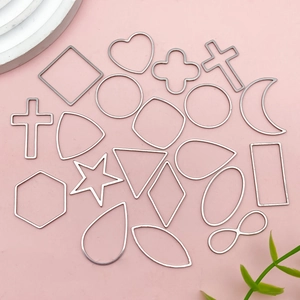 Macro detail of various geometric stainless steel DIY jewelry frames on pink background