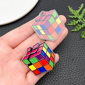 Detailed close-up of acrylic cube charms with colorful mosaic patterns and transparent edges