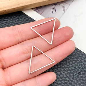 Macro shot of silver stainless steel hollow triangle charms for DIY earring making