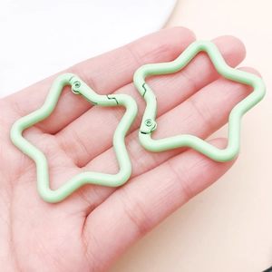 Close-up of mint green star-shaped spring snap hooks for DIY keychain accessories