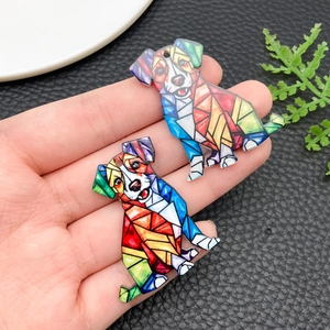 Macro detail of dog-shaped acrylic pendant with vibrant geometric mosaic art pattern