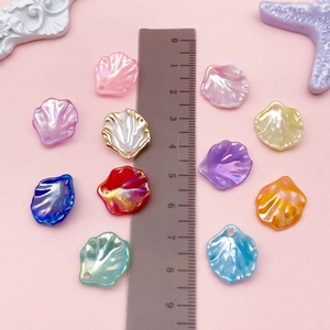 Macro shot of 2cm colorful shell-shaped acrylic beads with pearlescent finish for DIY jewelry