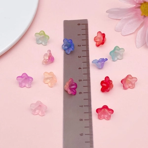 Macro shot of 10mm frosted acrylic bell flower beads in gradient colors for DIY jewelry