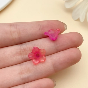 Macro detail of translucent pink acrylic trumpet flower beads for DIY jewelry making