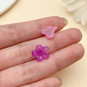 Close-up of translucent frosted gradient trumpet flower beads for DIY hairpins and jewelry
