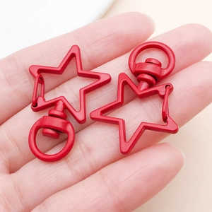 Macro detail of red star-shaped swivel lobster clasp for keychains and DIY crafts