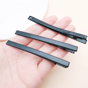 Three-piece set of matte black metal alligator hair clips with steel-stamped branding