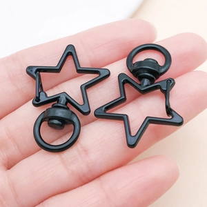 Close-up of matte black star-shaped lobster clasp key chain with swivel ring base