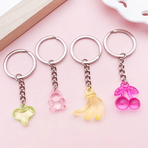 Colorful mixed acrylic heart bear cherry charms with silver keychains on pink background
