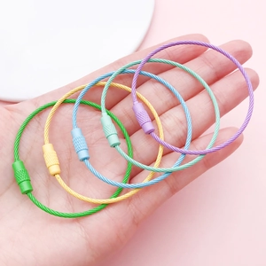 Hand holding colorful macaron coated steel wire keychains with screw locking mechanism