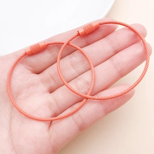 Detail of orange coated steel wire keychains with non-slip screw lock mechanism