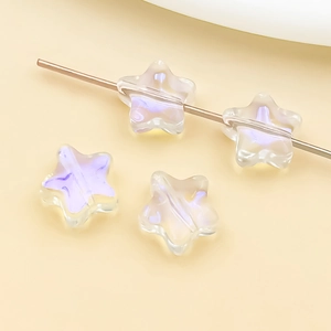 Macro detail of star shaped glass beads with iridescent purple finish for jewelry DIY