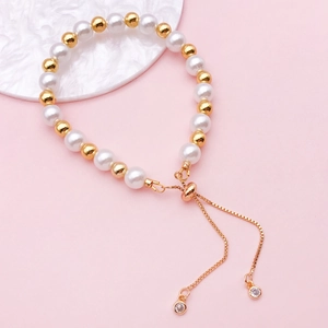 Adjustable pearl and gold bead bracelet with rhinestone charms and drawstring chain closure