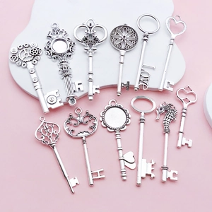 Detailed set of vintage silver alloy key pendants with heart and gear motifs