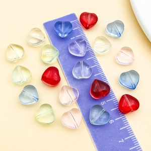 Macro detail of 10mm colorful transparent heart-shaped glass beads for DIY jewelry making