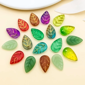 Macro detail of multi-colored glass leaf beads with gold veins for DIY jewelry making