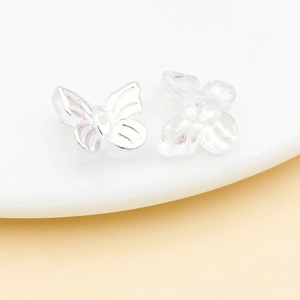 Macro shot of iridescent glass butterfly beads with detailed wing texture for DIY jewelry