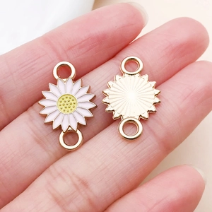 Macro detail of sunflower DIY pendant connector with white petals and golden metal back