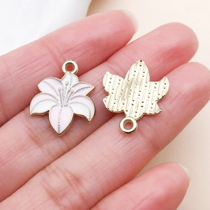 Macro detail of pink gradient lily flower pendants with golden back texture and loop