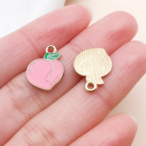 Detailed front and back view of a pink enamel peach pendant charm for DIY jewelry making
