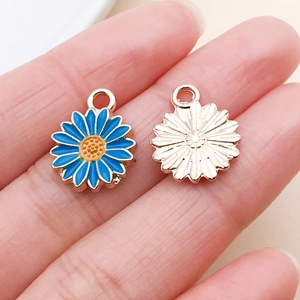 Macro detail of blue enamel daisy pendant with gold plating for DIY jewelry making