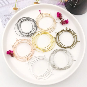 Assorted metallic DIY hoop earring findings in gold silver and bronze on white plate