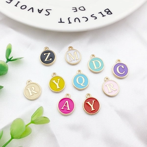 Detailed macro shot of assorted colorful enamel alloy letter charms for DIY jewelry making