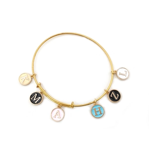 Detail of adjustable gold wire bracelet with six colorful enamel letter charms