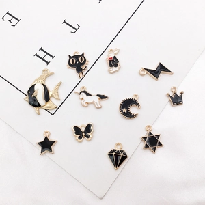 Detalle de dijes de aleación esmaltada DIY con formas de gato y conejo para joyería