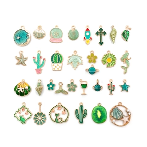 Assorted green enamel alloy charms featuring shells, leaves, and planets for DIY jewelry