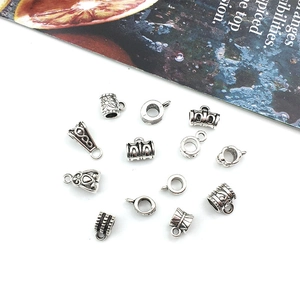 Flat lay of vintage silver alloy large hole beads and floral engraved bail connectors
