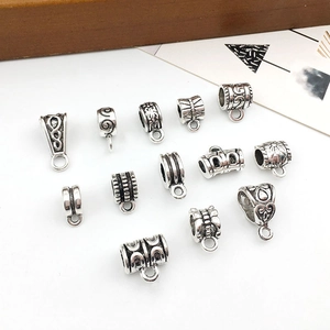 Detailed view of antique silver alloy bail beads with floral relief for DIY bracelets