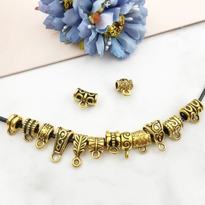 Antique gold alloy spacer beads with relief patterns on black cord for DIY jewelry