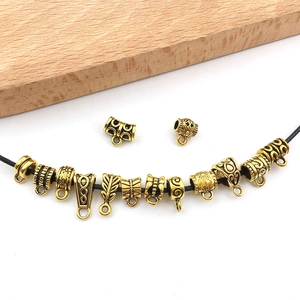 Detail of antique gold DIY jewelry connectors with intricate floral embossed patterns