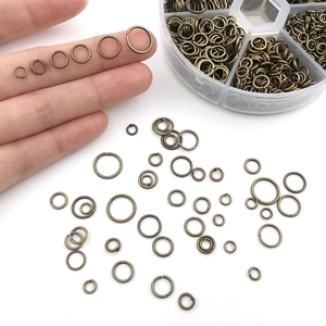 Antique bronze jump rings in various sizes for DIY jewelry making with storage box