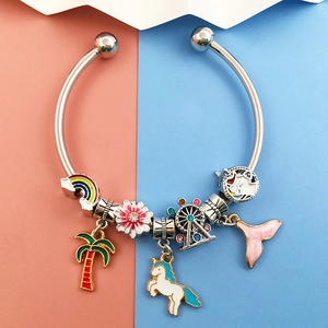 Detailed view of silver charm bracelet with colorful enamel unicorn and rainbow pendants