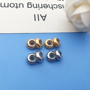 Macro shot of gold and silver copper slide beads with rubber core for jewelry making
