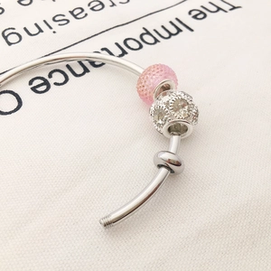 DIY silver bracelet with pink frosted bead, crystal pavé charm and positioning stopper bead