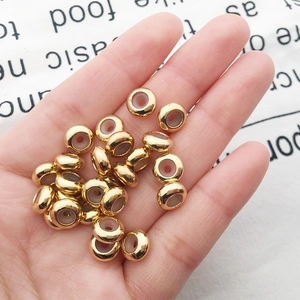 Close-up of golden abacus beads with silicone inner core for DIY jewelry adjusting