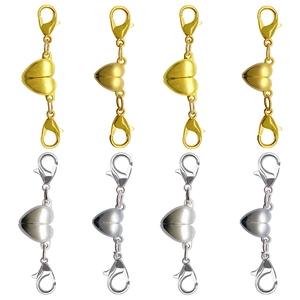 Macro detail of gold and silver heart-shaped magnetic lobster clasps for jewelry DIY