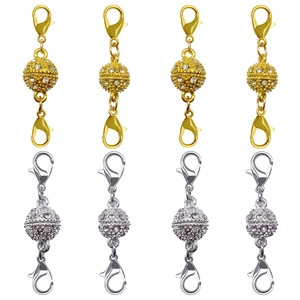 Macro detail of magnetic necklace clasps with rhinestones in gold and silver plating