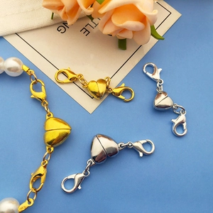 Macro detail of heart-shaped magnetic lobster clasps for DIY jewelry making in gold and silver