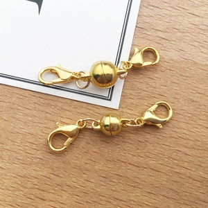 Close-up of golden magnetic lobster clasps for DIY necklace and bracelet jewelry making
