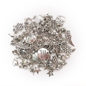 Detailed macro view of vintage silver DIY charms including stars and inspirational tag