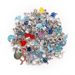 Detailed view of mixed enamel ocean and astronomy themed charms for DIY bracelets