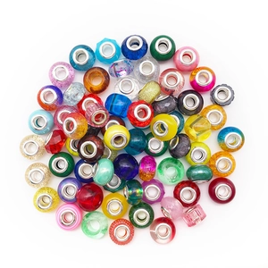 Detailed close-up of mixed colorful glass and resin large hole beads for DIY jewelry making