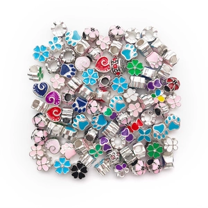 Macro detail of mixed colorful enamel charms and crystal beads for DIY bracelet making