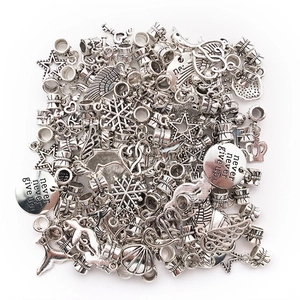 Macro shot of assorted silver alloy DIY charms with stars, crowns and inspirational text